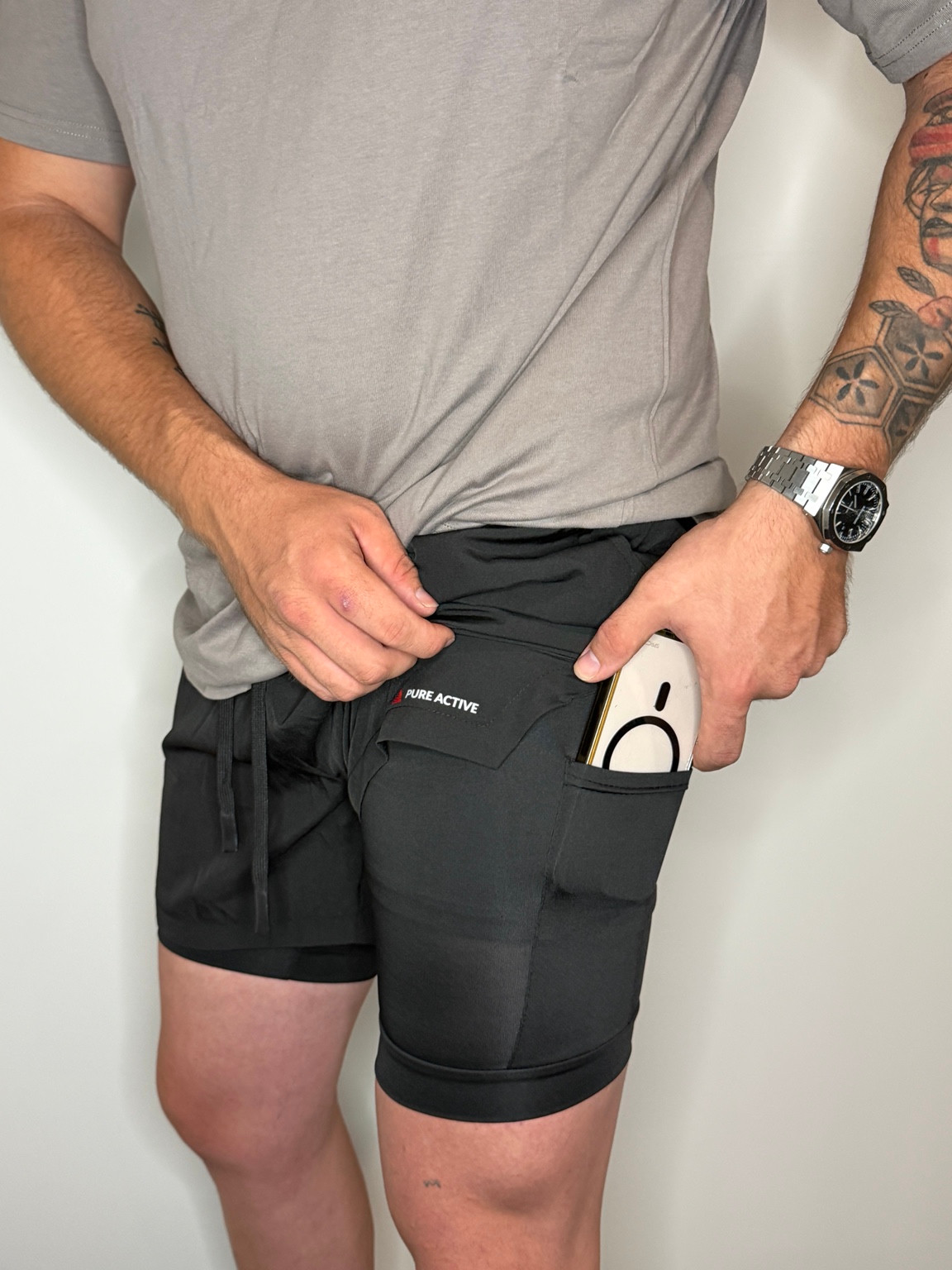 Pure Active black training shorts showing the phone pocket